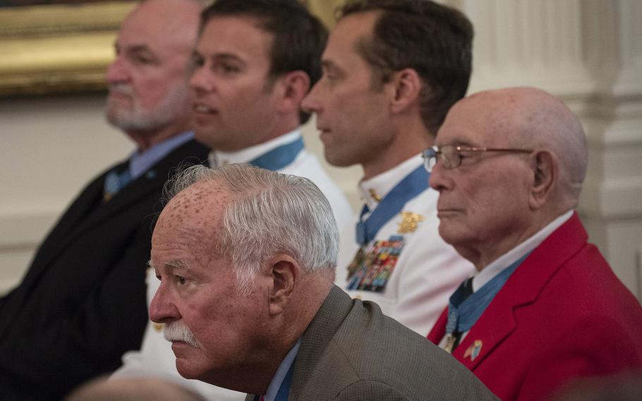 Medal of Honor recipients Harvey "Barney" Barnum, Hershel Williams, Britt Slabinski, Edward C. Byers Jr. and Brian Thacker, front to rear, listen during a Medal of Honor ceremony for the late Air Force Tech. Sgt. John Chapman at the White House, Aug. 22, 2018.