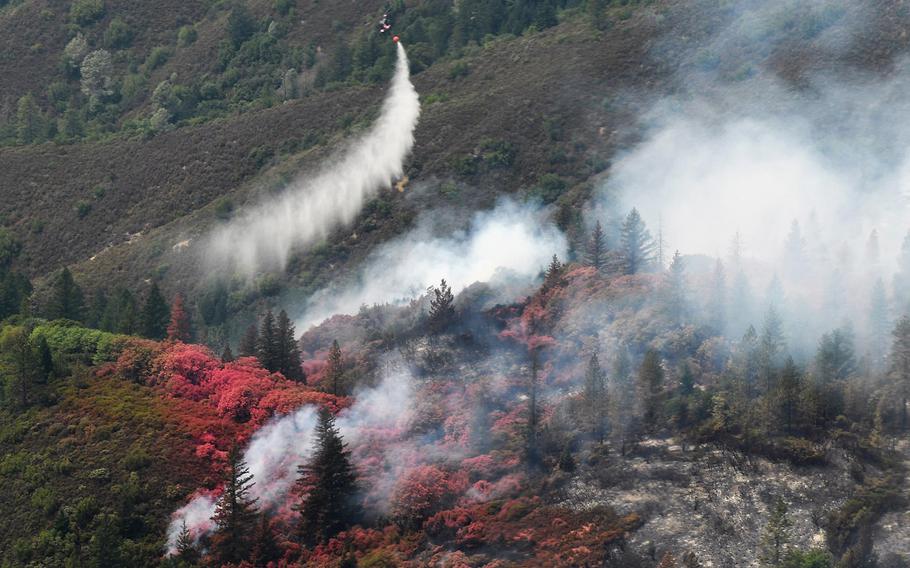 Pink fire retardant dropped from a National Guard aircraft into the Mendocino Complex in California fire is seen on Aug. 7, 2018.