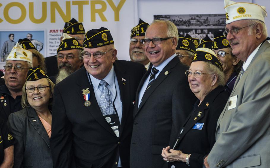 Rep. Tim Walz, D-Minn., ranking member of the House Veterans' Affairs Committee, poses with veterans at the American Legion's national convention in Minneapolis, Minn., Wednesday, Aug. 29, 2018.