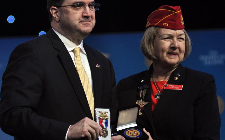 American Legion National Commander Denise Rohan presents parting gifts to Department of Veterans Affairs Secretary Robert Wilkie following his address to the organization's national convention Wednesday, Aug. 29 in Minneapolis, Minn. Wilkie underscored the importance of the Legion's advocacy in the group's 100-year history and reassured members the Legion still maintained influence at the VA.