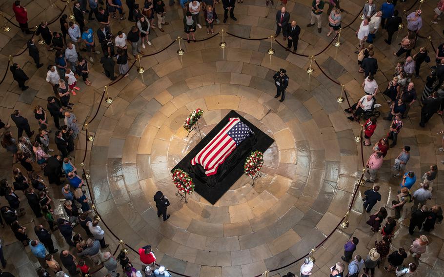 A steady stream of visitors pass through the U.S. Capitol's Rotunda where the late Sen. John McCain was lying in state on Friday, Aug. 31, 2018, in Washington.