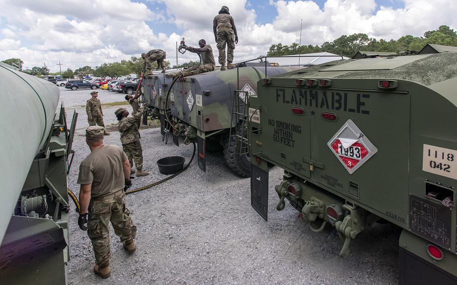 South Carolina National Guard Soldiers from the 118th Forward Support Company transfer bulk diesel fuel into M987 HEMTT fuel tanker trucks for distribution in preparation to support partnered civilian agencies and safeguard the citizens of the state in advance of Hurricane Florence, in North Charleston, S.C., September 10, 2018.