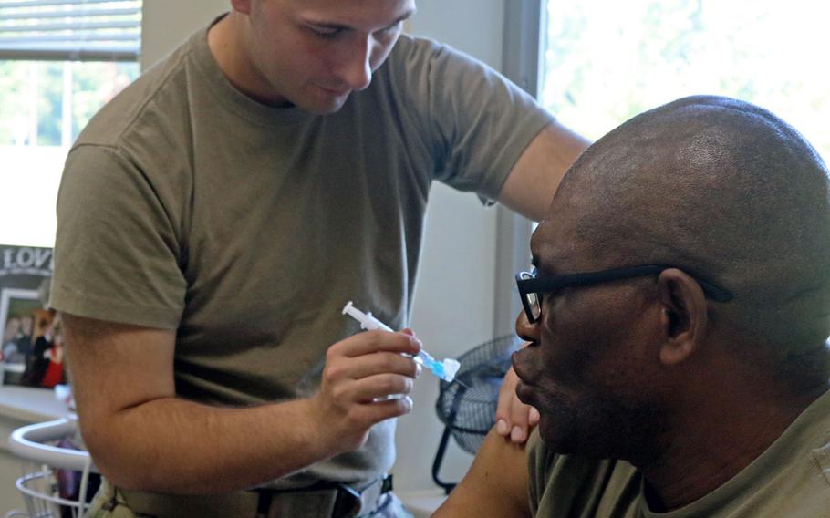 A Fort Drum soldier administers a vaccine to a 548th Combat Sustainment Support Battalion soldier on Thursday, Sept. 13, 2018 in preparation for Hurricane Florence. They were preparing for rapid deployment to areas struck by the storm.