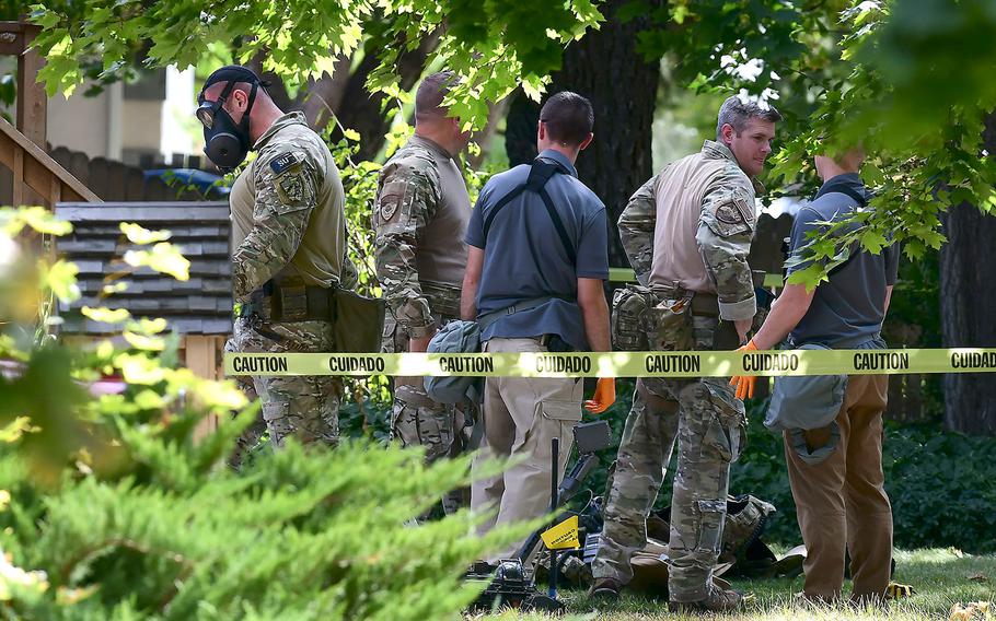 Law enforcement officers search a house on Wednesday, Oct. 3, 2018, in Logan, Utah. A man suspected of mailing suspicious letters to the Pentagon and President Donald Trump was taken into custody at the scene.