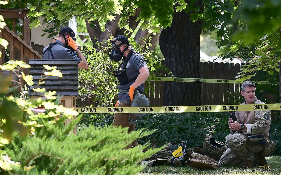 Law enforcement officers search a house on Wednesday, Oct. 3, 2018, in Logan, Utah.