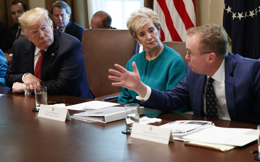 President Donald Trump and Small Business Administration administrator Linda McMahon listen as Director of the Office of Management and Budget Mick Mulvaney speaks during a cabinet meeting in the Cabinet Room of the White House, Wednesday, Oct. 17, 2018.