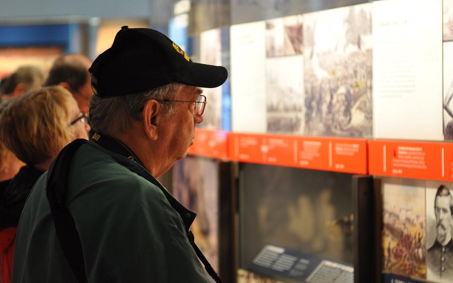 Visitors to the new National Veterans Memorial and Museum in Columbus, Ohio, read through the exhibits Sunday, Oct. 28. The museum, which opened Saturday, aims to share stories of individual veterans from different backgrounds, military branches and eras.