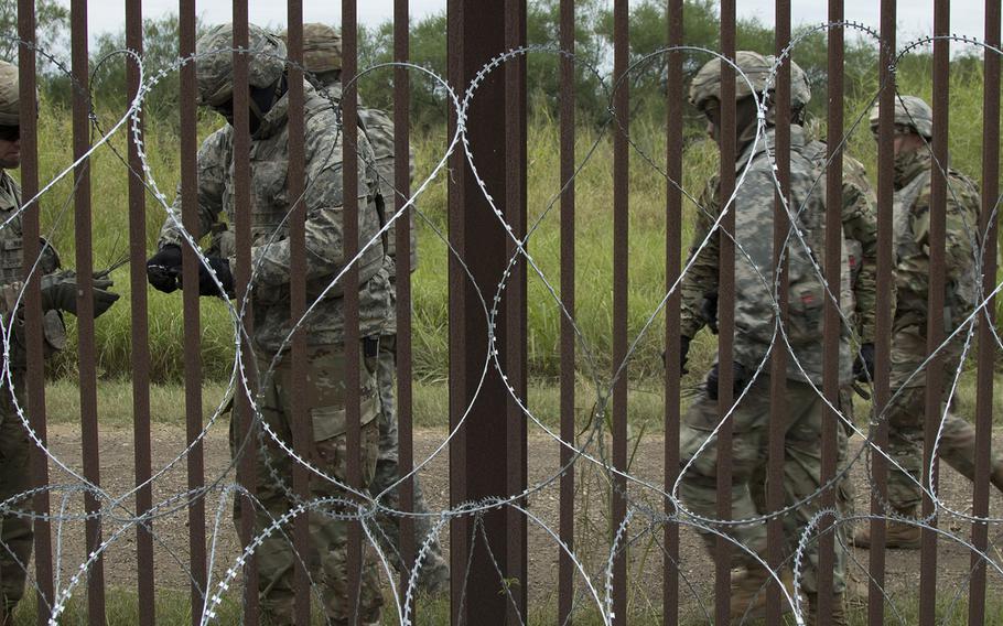 U.S. Army engineers from the 887th Engineer Support Company apply concertina wire in the Brownsville area Nov. 13, 2018.
