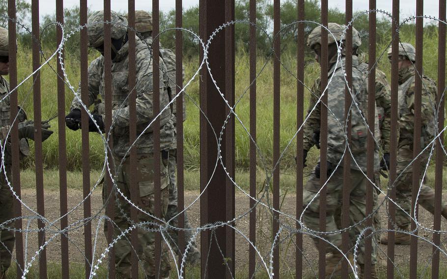 U.S. Army engineers from the 887th Engineer Support Company apply concertina wire in the Brownsville area Nov. 13, 2018. 