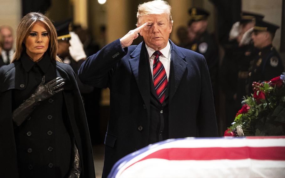 President Donald Trump and first lady Melania Trump pay their respects to former President George H.W. Bush in the Capitol rotunda, Dec. 3, 2018.