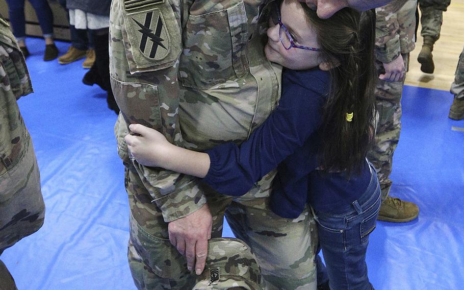 Seven-year-old Julianna runs to embrace her father First sergeant Archer Ford at the conclusion of the Georgia National Guard's 48th Brigade Combat Team Casing of Color and Departure Ceremony for their deployment to Afghanistan on Friday, Dec. 21, 2018.