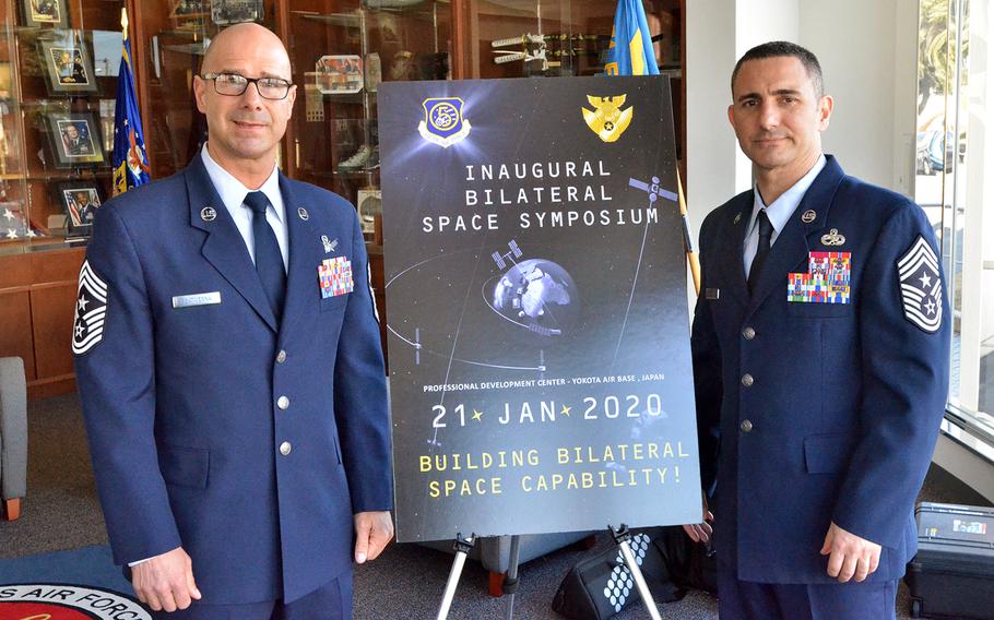 Chief Master Sgt. John Bentivegna, left, senior noncommissioned officer for Combined Force Space Component Command and Space Operations Command, poses with Chief Master Sgt. Brian Kruzelnick, the 5th Air Force command chief, during a Space Symposium on Yokota Air Base, Japan, Tuesday, Jan. 21, 2020.
