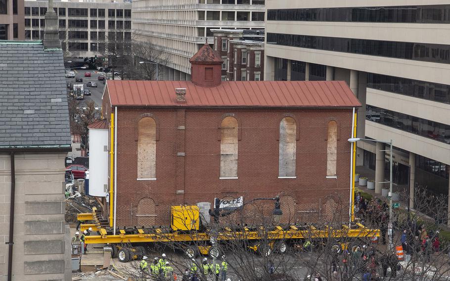 Washington's oldest synagogue building is turned sideways as it arrives at its permanent location at the Lillian and Albert Small Jewish Museum site on January 9, 2019.