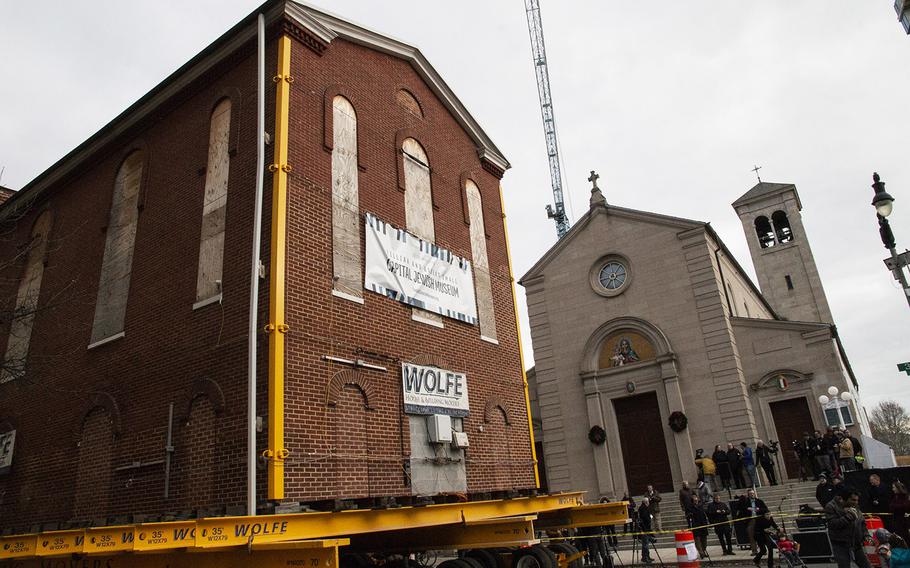 Washington's oldest synagogue building slowly rolls past Holy Rosary Catholic Church on January 9, 2019.