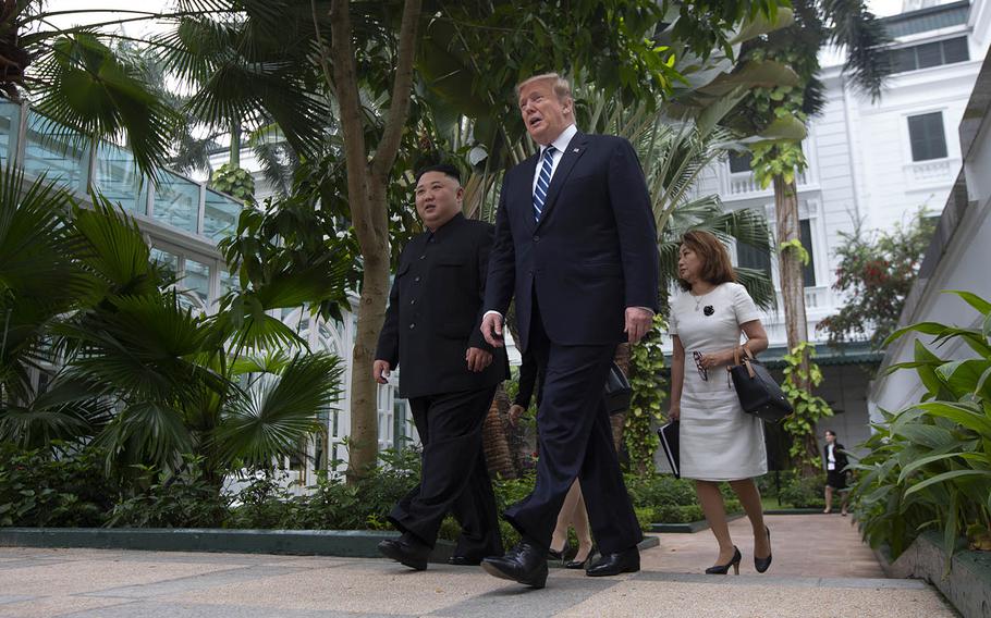 President Donald Trump and North Korean leader Kim Jong Un take a walk after their first meeting at the Sofitel Legend Metropole Hanoi hotel, Thursday, Feb. 28, 2019, in Hanoi. 