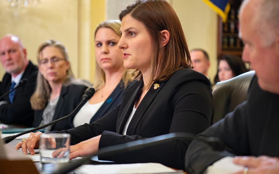 Army veteran Angela Bapp testifies on Wednesday, March 6, 2019, during a Senate Armed Services subcommittee hearing on Capitol Hill in Washington, where she and other witnesses spoke on the need for the military to revamp its prevention of and response to sexual assault. Looking on at right is retired Air Force Col. Doug James, president of Save Our Heroes. Looking on from left are retired Air Force Col. Don Christensen, president of Protect our Defenders; retired Army Col. Ellen Haring, chief executive officer of Service Women's Action Network; and Navy Lt. Cmdr. Erin Leigh Elliott.