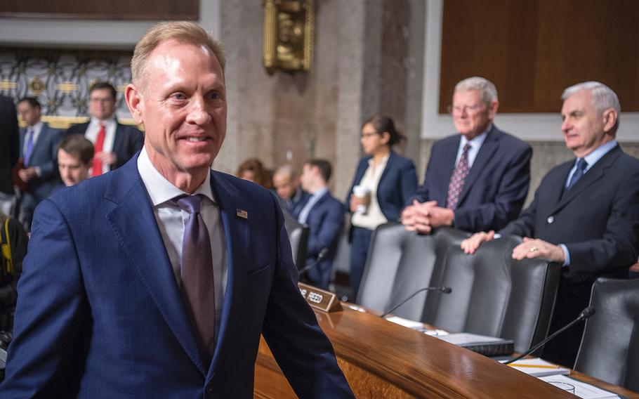 Acting Secretary of Defense Patrick Shanahan arrives for a Senate Armed Services Committee hearing on Capitol Hill in Washington on Thursday, March 14, 2019. The committee's Chairman Sen. Jim Inhofe, R-Okla., and the Ranking Member Sen. Jack Reed, D-R.I., look on at the right.