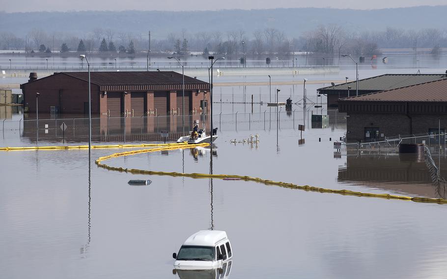 Contracted employees of the Environmental Restoration, LLC company deploy a spill containment boom around the Offutt Air Force Base fuel storage area as a precautionary measure March 18, 2019 following flooding of the southeast portion of the base. 