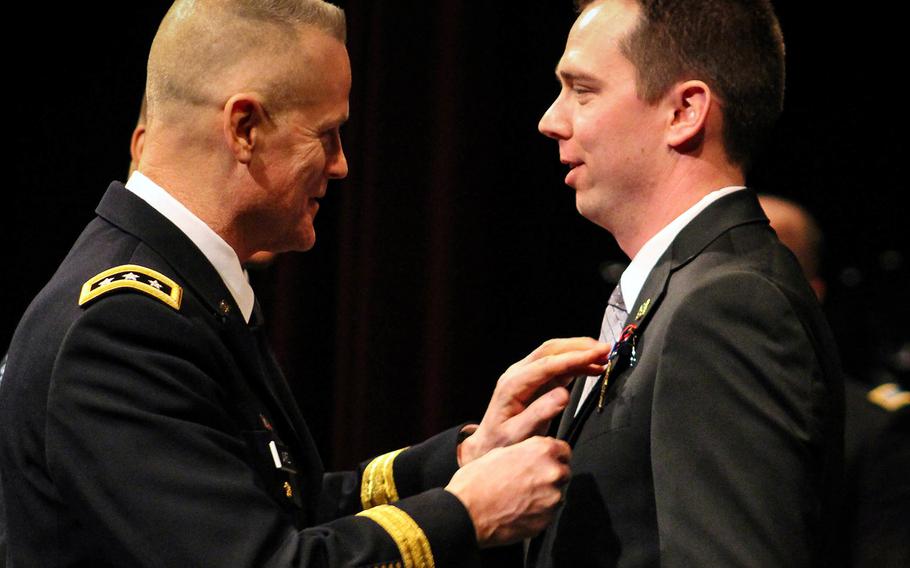 Lt. Gen. Thomas James, Jr., commander of First Army, pins Andrew Bundermann with the Distinguished Service Cross.