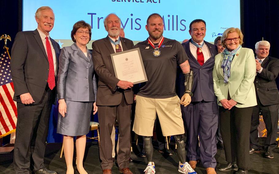 Travis Mills, center, was awarded the 2019 Citizen Honors Service Act Award on Monday, March 25, 2019, for his work with the Travis Mills Foundation, which provides getaways for veterans suffering from service-related injuries. 