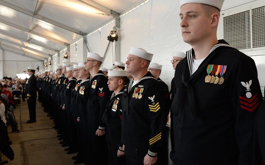 Sailors wearing red or  yellow stripes stand in formation during the commissioning ceremony of the USS South Dakota on Feb. 2, 2019.