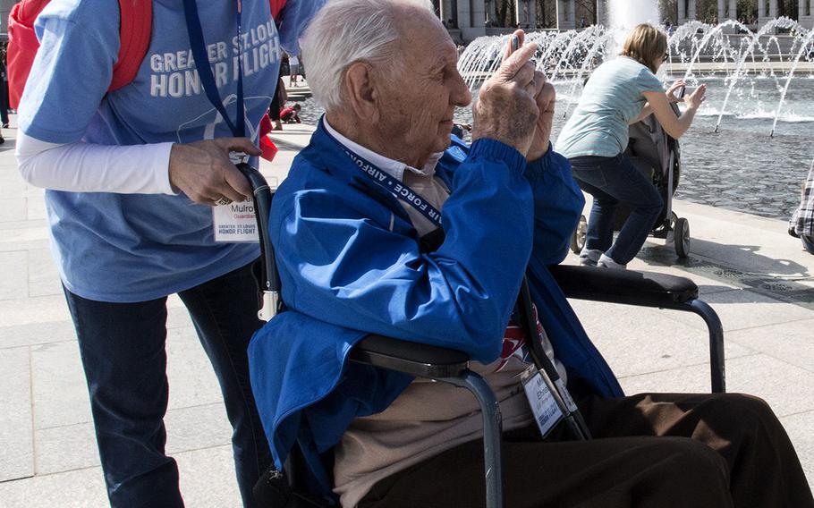 Greater St. Louis Honor Flight participant Mike Ehnatko takes a photo at the National World War II Memorial in Washington, D.C., March 30, 2019.