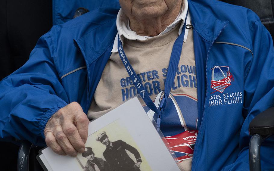 Army Air Corps veteran Mike Ehnatko holds a vintage photo of himself as Greater St. Louis Honor Flight visits the National World War II Memorial in Washington, D.C., March 30, 2019.
