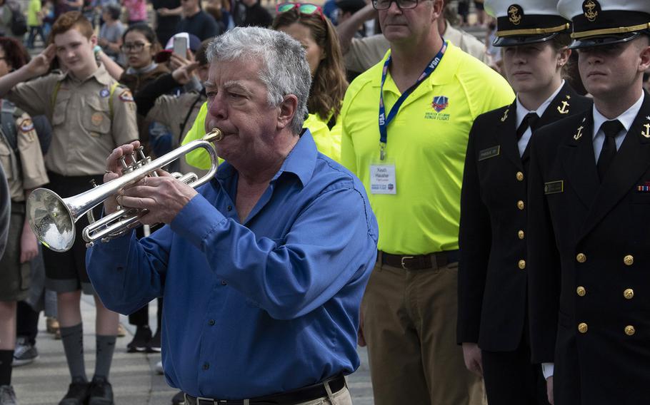 A bugler plays taps as Greater St. Louis Honor Flight visits the National World War II Memorial in Washington, D.C., March 30, 2019.