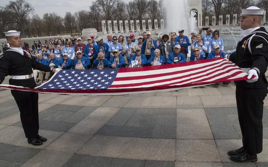 Ceremonial guard members hold a flag during a ceremony with Greater St. Louis Honor Flight veterans at the National World War II Memorial in Washington, D.C., March 30, 2019.