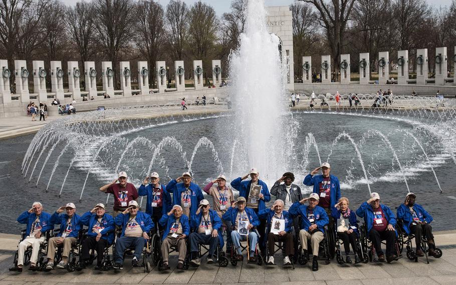 Veterans from the Greater St. Louis Honor Flight salute during a visit to the National World War II Memorial in Washington, D.C., March 30, 2019.
