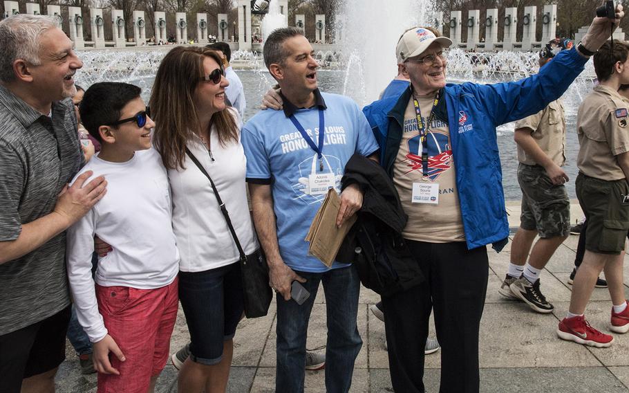 Navy veteran George Souris takes a selfie as the Greater St. Louis Honor Flight visits the National World War II Memorial in Washington, D.C., March 30, 2019. Next to him is his guardian for the flight. Army Col. Adonis Chakides.