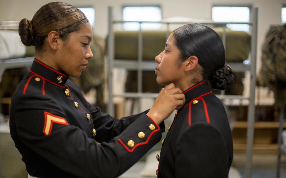 Pfc. Kathy Espinoza, from New York City, N.Y. inspects the uniform of Pvt. Arella Aleman, from Dallas, Texas Nov. 9, 2018 at Marine Corps Recruit Depot Parris Island, S.C.