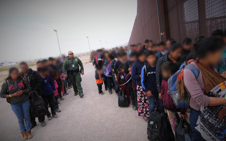 U.S. Border Patrol agents assigned to El Paso Station corral a group of approximately 127 migrants at the U.S.-Mexico border, March 7, 2019.