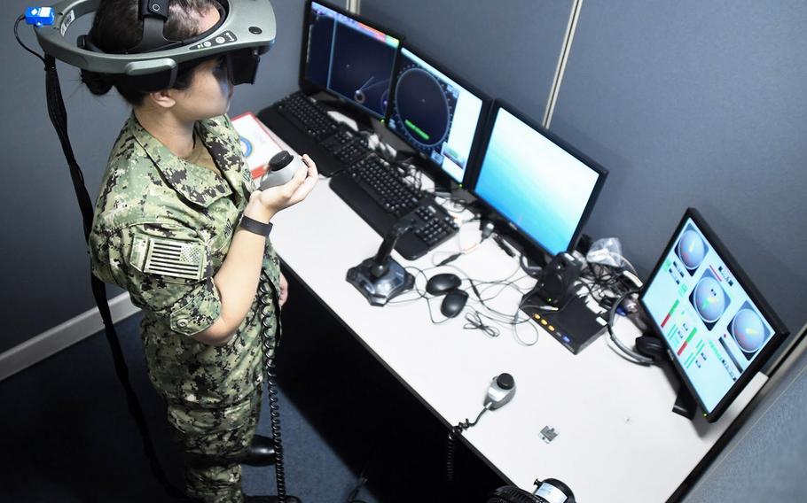 In a July, 2018 file photo, a Basic Division Officer Course student at Surface Warfare Officers School, Det. San Diego, practices navigation in the Conning Officer Virtual Environment (COVE) shiphandling simulator, which provides state-of-the-art navigation and shiphandling training and can emulate the Navy's homeports and almost every routine port of call around the world. Constructing better training simulators for sailors on surface ships is one of the initiatives being undertaken by the Navy.