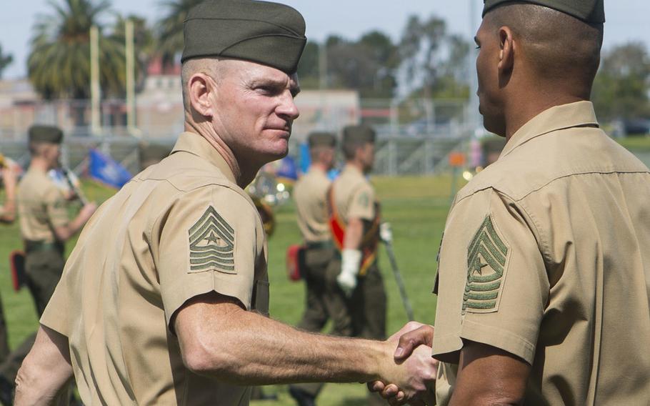 U.S. Marine Sgts. Maj. Troy E. Black, left, and Lonnie N. Travis shake hands after a ceremony at Camp Pendleton, Calif., April 7, 2017.