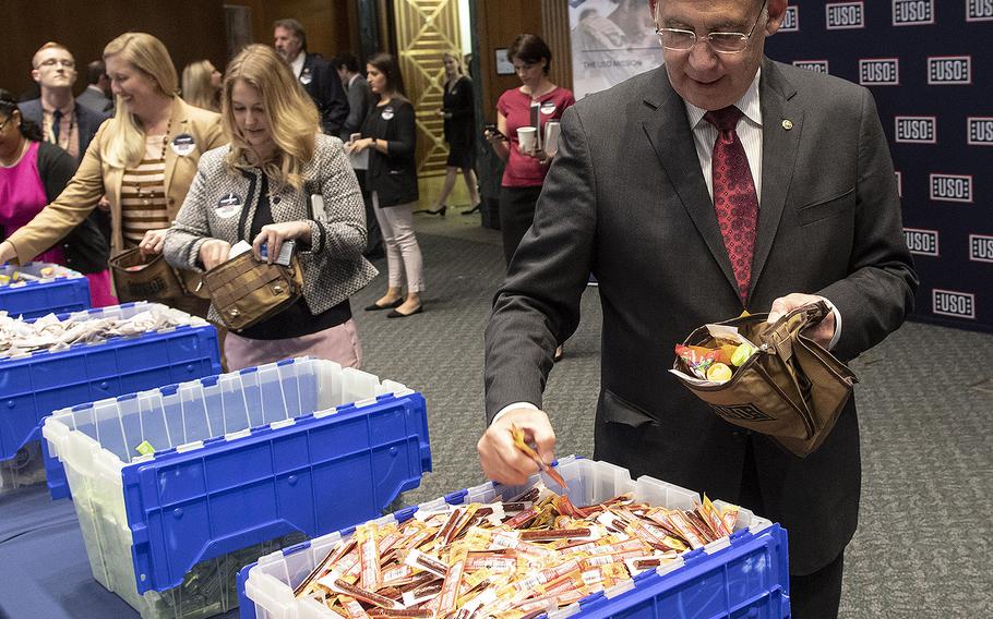 Members of Congress and other volunteers prepare snack packages for U.S. servicemembers during a USO event at the Dirksen Senate Office Building on Capitol Hill, April 30, 2019.