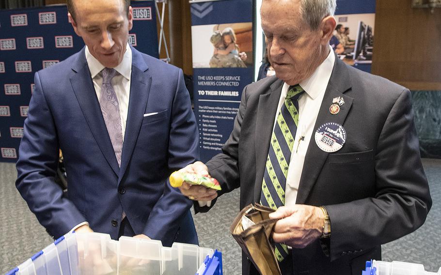 Rep. Joe Wilson, R-S.C., right, prepares a snack package for U.S. servicemembers during a USO event at the Dirksen Senate Office Building on Capitol Hill, April 30, 2019.