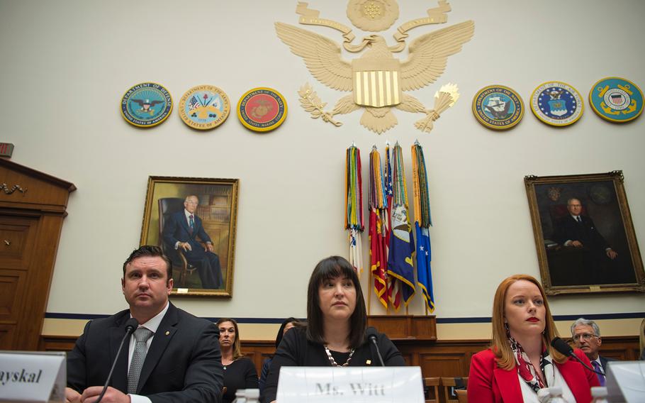 Army Green Beret Sgt. 1st Class Richard Stayskal, Alexis Witt, widow of Air Force Staff Sgt. Dean Witt, and Air Force veteran Rebecca Lipe take their seats as they prepare to testify during a hearing on Capitol Hill in Washington on Tuesday, April 30, 2019.