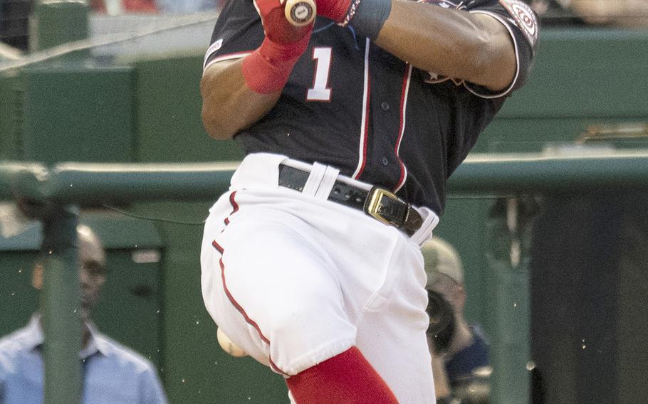 Wilmer Difo of the Washington Nationals twists himself to the ground on a swing against the St. Louis Cardinals at Nationals Park in Washington, Wednesday, May 1, 2019.