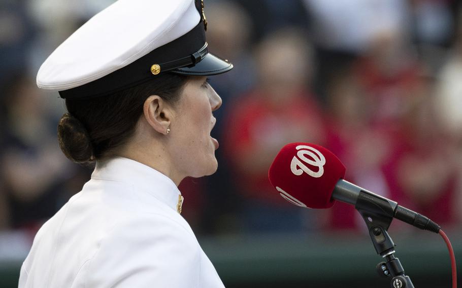 Musician 1st Class Maia Rodriguez, a member of the U.S. Navy Band, sings the national anthemduring Navy Night ceremonies at Nationals Park in Washington, D.C., May 1, 2019.