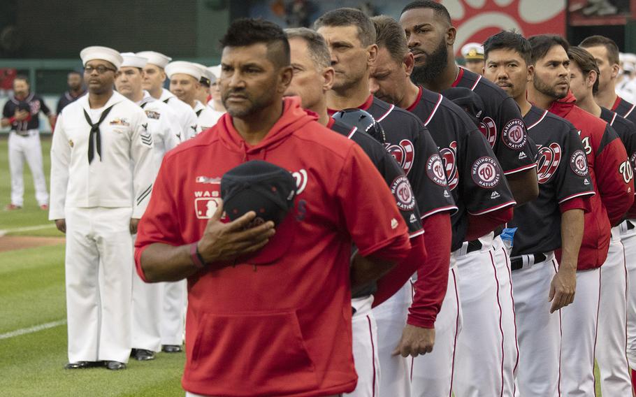 Washington Nationals manager Dave Martinez and his coaches and players stand for the national anthem during Navy Night ceremonies at Nationals Park in Washington, D.C., May 1, 2019.