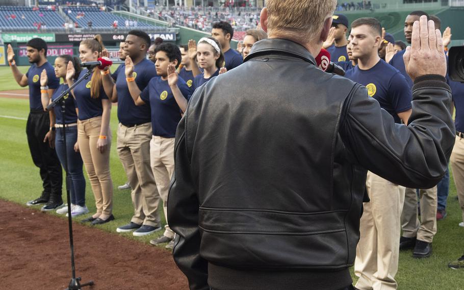 Under Secretary of the Navy Thomas B. Modly leads 45 new U.S. Navy sailors through an enlistment ceremony during Navy Night at Nationals Park in Washington, D.C., May 1, 2019.