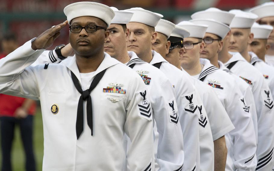 Sailors salute as the national anthem is played during Navy Night ceremonies at Nationals Park in Washington, D.C., May 1, 2019.