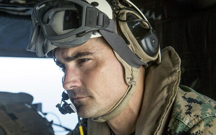 In a Nov. 17, 2018 file photo, U.S. Marine Corps Lt. Col. Francisco Zavala, commanding officer of Special Purpose Marine Air-Ground Task Force-Peru, looks out over the Pacific Ocean as he flies in a UH-1Y Venom