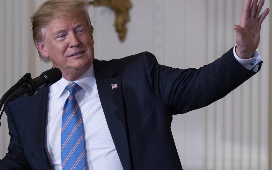 President Donald Trump waves to an audience member who shouted "thank you" during his speech at the third annual Celebration of Military Mothers at the White House, May 10, 2019.