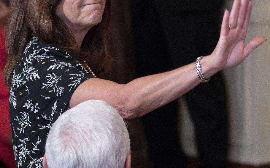 Karen Pence, the mother of a Marine Corps officer, waves to the crowd as she's singled out by President Donald Trump during the third annual Celebration of Military Mothers at the White House, May 10, 2019.