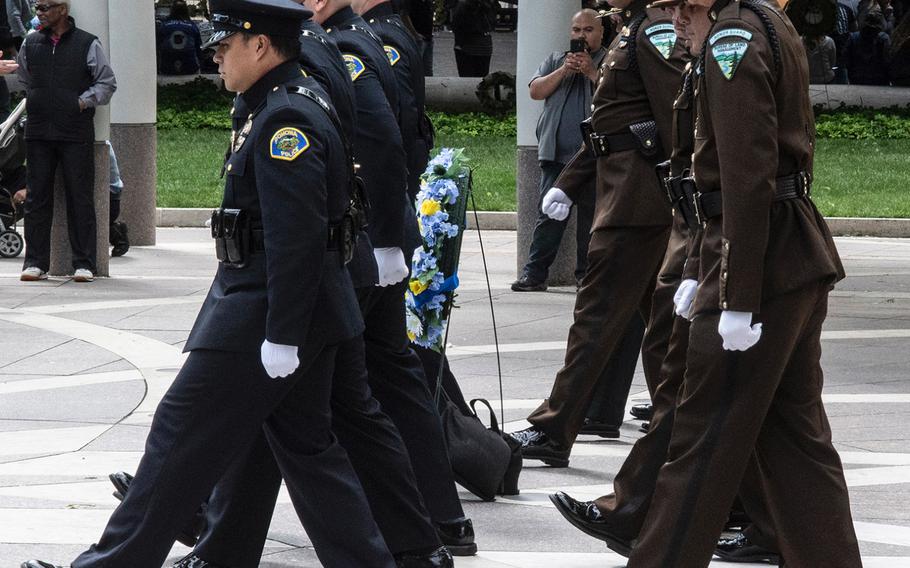 Honor guard representatives of the Pomona, Calif., police department, left, and the Bureau of Land Management change shifts during National Police Week at the National Law Enforcement Officers Memorial in Washington, D.C., May 14, 2019.