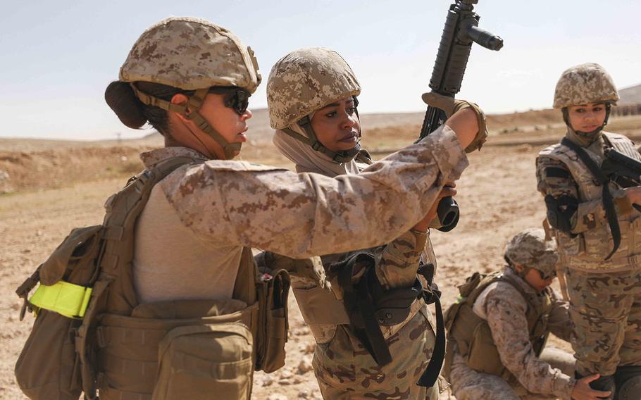 U.S. Marine Sgt. Nicole Turner, left, and a soldier from the Jordan Armed Forces-Arab Army clear a weapon after completing a live fire combat marksmanship range in Zarqa, Jordan on April 23, 2019.