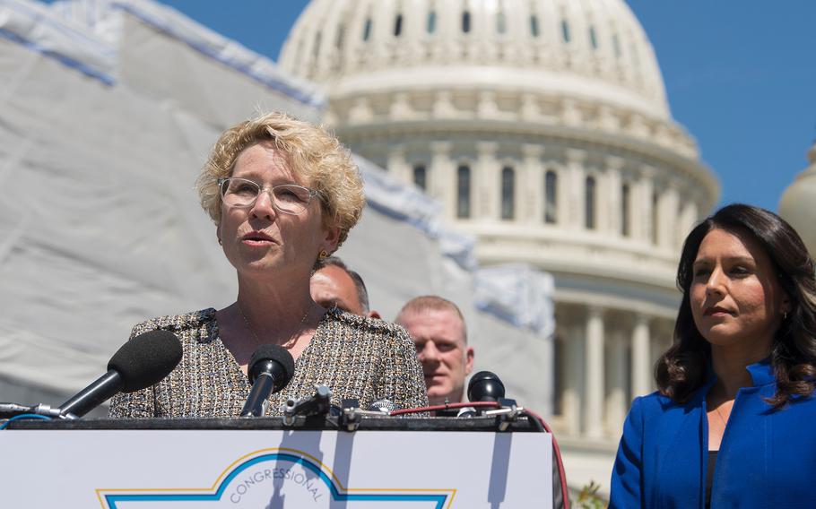 Former Air Force officer Rep. Chrissy Houlahan, D-Pa., announces the launching of the Servicewomen and Women Veterans Caucus that will focus on women's issues in the military. Army National Guard officer and caucus co-founder Rep. Tulsi Gabbard, D-Hawaii, looks on at right during the ceremony outside the U.S. Capitol in Washington on Wednesday, May 15, 2019.