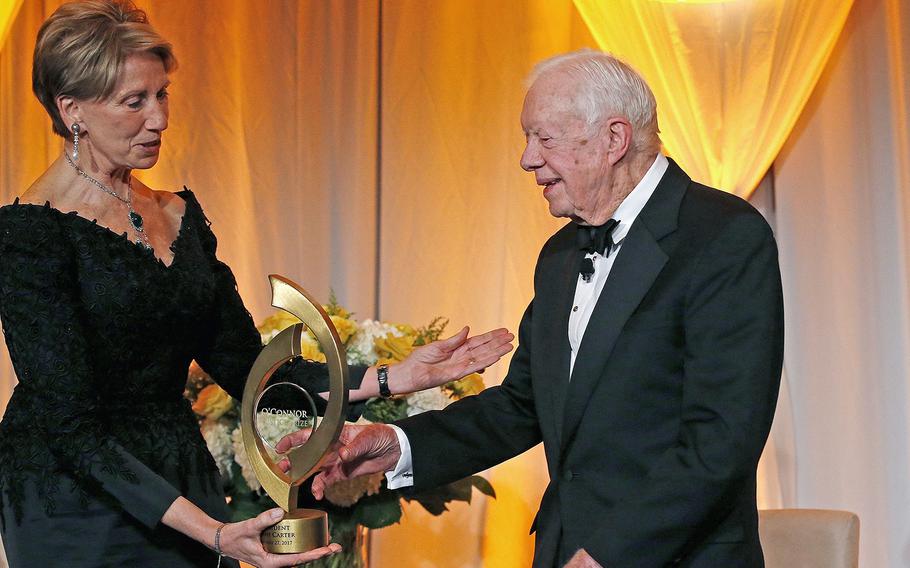 Former President Jimmy Carter accepts the O'Connor Justice Prize from former U.S. Ambassador to Finland Barbara Barrett, left, in Phoenix on Jan. 27, 2017. 